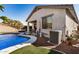 Inviting backyard with a beautiful pool, covered patio, and comfortable outdoor seating on a sunny day at 17704 W Tasha Dr, Surprise, AZ 85388