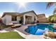 Stunning backyard featuring a refreshing pool, covered patio, and charming decor under a bright, sunny sky at 17704 W Tasha Dr, Surprise, AZ 85388