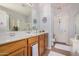 Bathroom featuring a large mirror, white countertops, and a glass-enclosed shower at 17704 W Tasha Dr, Surprise, AZ 85388