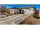 Charming single-story home featuring a spacious driveway and well-maintained landscaping at 17704 W Tasha Dr, Surprise, AZ 85388