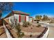 Charming home exterior features desert landscaping, a white picket fence, and mature trees at 17704 W Tasha Dr, Surprise, AZ 85388