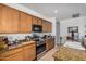 Kitchen with granite counters, stainless steel appliances, and wooden cabinets at 17704 W Tasha Dr, Surprise, AZ 85388