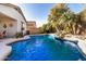 Lush backyard with custom pool and waterfall at 17704 W Tasha Dr, Surprise, AZ 85388