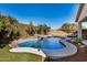 Private backyard oasis with custom pool, spa, and waterfall feature at 17704 W Tasha Dr, Surprise, AZ 85388