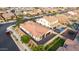 An aerial view of a well-maintained home featuring a sparkling pool and lush green landscaping in a residential neighborhood at 19057 W Yucatan Dr, Surprise, AZ 85388