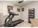 A home exercise room featuring a treadmill and functional decor for a dedicated workout space at 19057 W Yucatan Dr, Surprise, AZ 85388