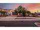 Home exterior with desert landscaping, tile roof, and three-car garage at 19057 W Yucatan Dr, Surprise, AZ 85388