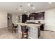 A modern kitchen with a large central island featuring stylish pendant lighting and bar seating at 19057 W Yucatan Dr, Surprise, AZ 85388