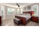 Main bedroom featuring natural light, ceiling fan and wood look flooring at 19057 W Yucatan Dr, Surprise, AZ 85388