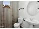 Rustic style powder room featuring a toilet and sink at 1920 E Bell Rd # 1153, Phoenix, AZ 85022