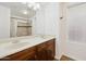 Bathroom with double sink vanity and shower/tub combo with tile surround at 1920 E Bell Rd # 1153, Phoenix, AZ 85022