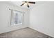 An empty bedroom with carpet, ceiling fan, and window at 1920 E Bell Rd # 1153, Phoenix, AZ 85022