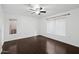 Bright bedroom with hardwood floors, a ceiling fan, and natural light from two windows at 1920 E Bell Rd # 1153, Phoenix, AZ 85022