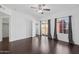 Bedroom with dark hardwood floors, modern ceiling fan, blackout curtains and balcony access at 1920 E Bell Rd # 1153, Phoenix, AZ 85022