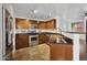 View of kitchen featuring stainless steel appliances, wooden cabinets, dark countertops, and a copper sink basin at 1920 E Bell Rd # 1153, Phoenix, AZ 85022