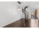 Spacious living room with dark hardwood floors, spiral staircase and decorative chandelier, and a sliding door to the outside at 1920 E Bell Rd # 1153, Phoenix, AZ 85022