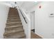 Carpeted staircase with white walls and a handrail leading to the upper level of the home at 1920 E Bell Rd # 1153, Phoenix, AZ 85022