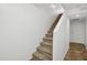 Carpeted staircase with white walls and a handrail leading to the upper level of the home at 1920 E Bell Rd # 1153, Phoenix, AZ 85022