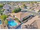 Aerial view of a home with a pool, covered patio, and lush landscaping in a well-manicured neighborhood at 2091 E Flintlock Way, Chandler, AZ 85286