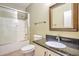 Bathroom featuring a shower, toilet, and a single sink vanity at 2091 E Flintlock Way, Chandler, AZ 85286