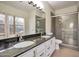 Bathroom featuring a double sink vanity and glass enclosed shower at 2091 E Flintlock Way, Chandler, AZ 85286