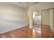 Minimalist bedroom with hardwood floors and a mirrored sliding closet door at 2091 E Flintlock Way, Chandler, AZ 85286