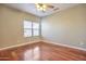 Comfortable bedroom featuring hardwood floors and a ceiling fan at 2091 E Flintlock Way, Chandler, AZ 85286