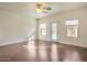 Large bright bedroom with hardwood floors, a ceiling fan, and a view of the pool at 2091 E Flintlock Way, Chandler, AZ 85286