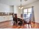 Elegant dining room with hardwood floors, granite counter, and a modern chandelier at 2091 E Flintlock Way, Chandler, AZ 85286