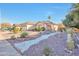 Charming front yard features desert landscaping, including a decorative rock garden and a fountain at 2091 E Flintlock Way, Chandler, AZ 85286