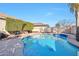 Inviting pool area surrounded by lush landscaping, offering a private outdoor oasis at 2091 E Flintlock Way, Chandler, AZ 85286