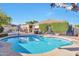 Beautiful pool area with covered patio and manicured landscaping, perfect for outdoor living at 2091 E Flintlock Way, Chandler, AZ 85286