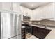 Well-lit kitchen features stainless steel appliances and contrasting white and brown cabinetry at 2101 S Yellow Wood -- # 22, Mesa, AZ 85209