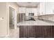 Modern kitchen featuring stainless steel appliances, white cabinets and stone countertops at 2101 S Yellow Wood -- # 22, Mesa, AZ 85209