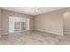 Open-concept living room with neutral paint and sliding door to the backyard at 2101 S Yellow Wood -- # 22, Mesa, AZ 85209