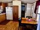 Traditional eat-in kitchen features wood cabinets, dining table and white appliances at 2121 N Center St # 138, Mesa, AZ 85201