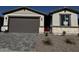 Charming single-story home featuring stone accents, neutral stucco, and a well-maintained front yard at 21555 N Rummler Ln, Maricopa, AZ 85138