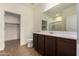 Bathroom with long vanity, large mirror, and adjacent walk in closet and glass shower at 2379 E San Miguel Dr, Casa Grande, AZ 85194