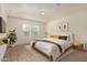 Staged bedroom features wood-look floors, two windows, and modern decor and furnishings at 2379 E San Miguel Dr, Casa Grande, AZ 85194