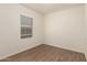 An empty bedroom offers new wood flooring and a window with modern blinds at 2379 E San Miguel Dr, Casa Grande, AZ 85194