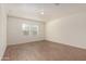 Neutral bedroom with two windows offering natural light and sleek wood-look floors at 2379 E San Miguel Dr, Casa Grande, AZ 85194