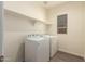 Well-lit laundry room with washer, dryer, and shelving for storage and supplies at 2379 E San Miguel Dr, Casa Grande, AZ 85194