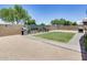 View of the expansive backyard featuring raised garden beds and lush greenery at 26020 N 138Th Ln, Peoria, AZ 85383