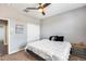 Bedroom featuring carpet flooring, a ceiling fan, and a closet with white doors at 26020 N 138Th Ln, Peoria, AZ 85383