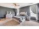 Main bedroom with a ceiling fan, carpet flooring, and a lightly colored wooden headboard at 26020 N 138Th Ln, Peoria, AZ 85383