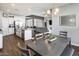 Open concept dining room with kitchen and living room views with wood-look tile flooring at 26020 N 138Th Ln, Peoria, AZ 85383