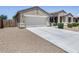 Exterior view showcasing the home's curb appeal and featuring a large driveway and garage at 26020 N 138Th Ln, Peoria, AZ 85383