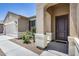 Charming front entrance featuring a covered porch, manicured landscaping and a welcoming front door at 26020 N 138Th Ln, Peoria, AZ 85383