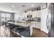 Kitchen with granite island, stainless appliances, breakfast bar seating, and white cabinetry at 26020 N 138Th Ln, Peoria, AZ 85383