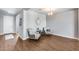 Open Living Room with decorative chairs, a large clock, and wood-look tile flooring, next to the entrance at 26020 N 138Th Ln, Peoria, AZ 85383